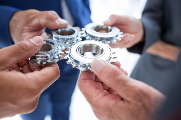 companeros-trabajo-sosteniendo-cog_13339-207636